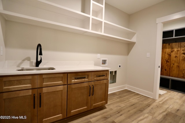 130 Gails Rd, West End, NC 27376 - laundry area with hookup for an electric dryer, cabinet space, hookup for a washing machine, and light wood-type flooring