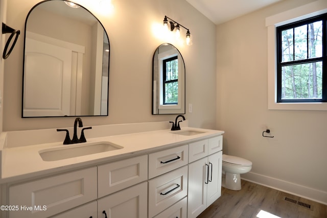 130 Gails Rd, West End, NC 27376 - full bath featuring healthy amount of natural light, double vanity, and wood finished floors