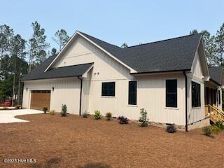 130 Gails Rd, West End, NC 27376 - view of front of house with a garage and concrete driveway