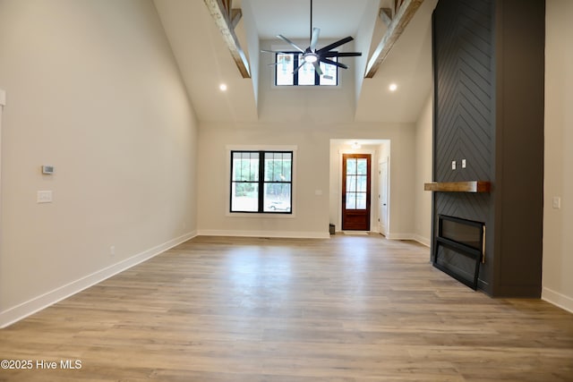 130 Gails Rd, West End, NC 27376 - unfurnished living room with a ceiling fan, a fireplace, high vaulted ceiling, and light wood-type flooring