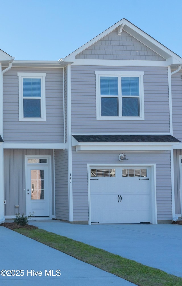 view of front of home featuring an attached garage and concrete driveway