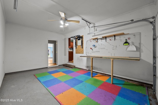 garage featuring ceiling fan and a workshop area