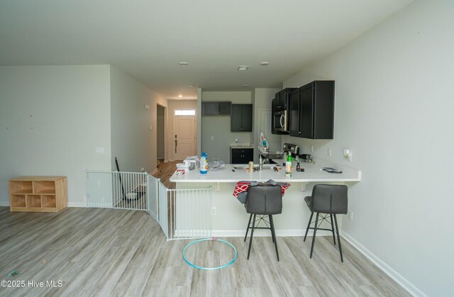 1741 Riverton Dr SE Lot 36, Bolivia, NC 28422 - kitchen with a peninsula, appliances with stainless steel finishes, light wood-style floors, and light countertops