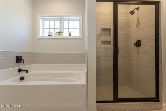 full bath featuring a bath and a shower stall