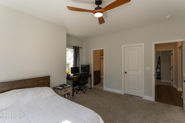 carpeted bedroom featuring baseboards, ensuite bath, and ceiling fan