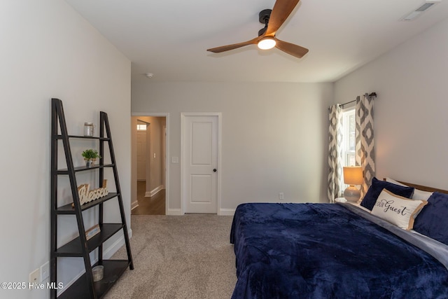 bedroom featuring baseboards, a ceiling fan, visible vents, and carpet