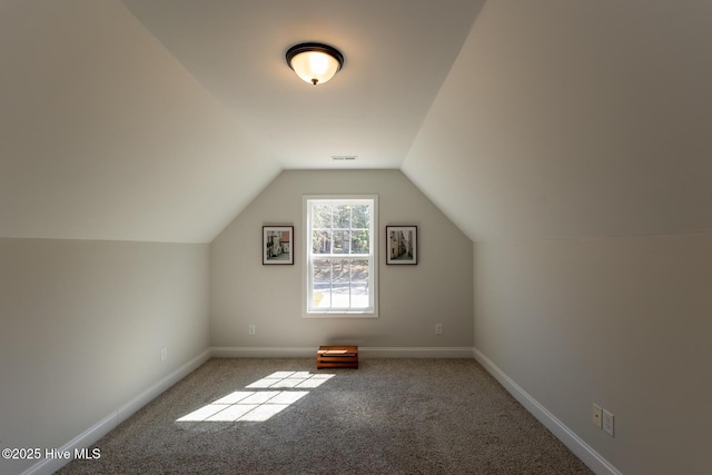 bonus room featuring baseboards, visible vents, carpet flooring, and vaulted ceiling