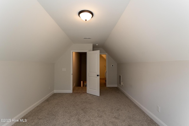bonus room featuring baseboards, lofted ceiling, visible vents, and carpet