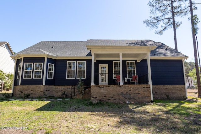 single story home with a front yard, covered porch, and brick siding