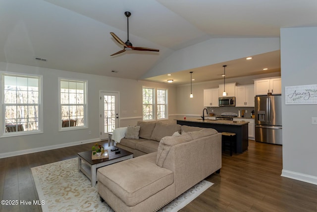 living room featuring vaulted ceiling, a ceiling fan, dark wood finished floors, visible vents, and recessed lighting