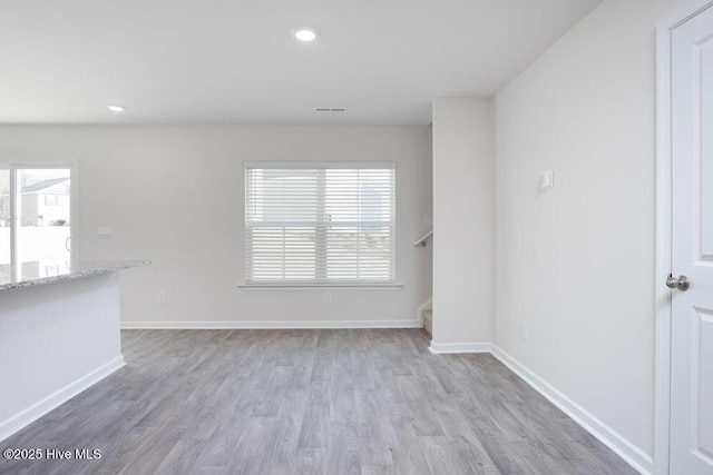 3806 Falcon Ct NW, Wilson, NC 27896 - unfurnished room with stairway, wood finished floors, baseboards, visible vents, and recessed lighting