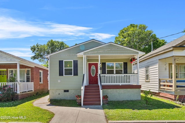 bungalow-style house with a front lawn, covered porch, and crawl space