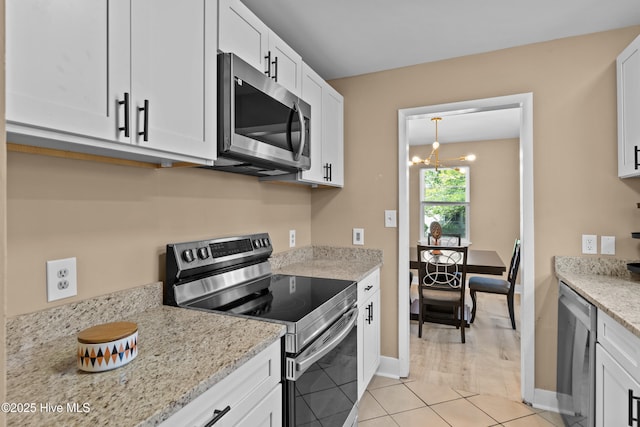 118 S 13th St, Wilmington, NC 28401 - kitchen featuring light stone counters, white cabinets, stainless steel appliances, and a notable chandelier