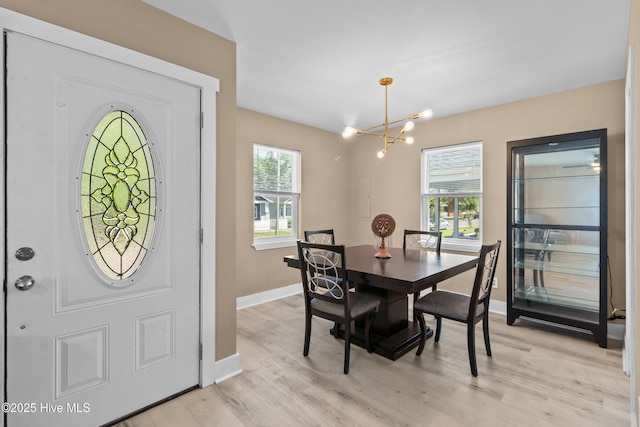 118 S 13th St, Wilmington, NC 28401 - dining space featuring an inviting chandelier, baseboards, and light wood-style flooring