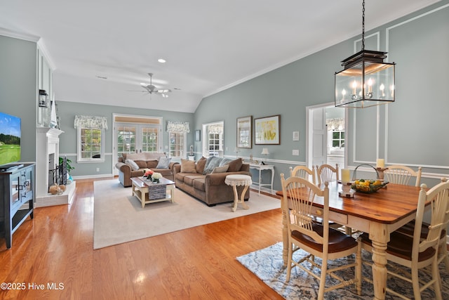 4106 Kittiwake Ct, Southport, NC 28461 - dining room with light wood-style floors, a ceiling fan, crown molding, a chandelier, and lofted ceiling