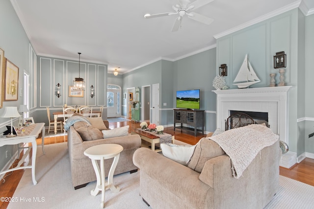4106 Kittiwake Ct, Southport, NC 28461 - living room featuring ornamental molding, ceiling fan, wood finished floors, a brick fireplace, and baseboards