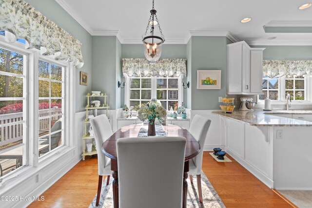 4106 Kittiwake Ct, Southport, NC 28461 - dining space featuring healthy amount of natural light, ornamental molding, light wood-style flooring, recessed lighting, and a chandelier