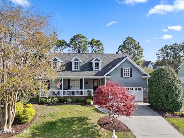 4106 Kittiwake Ct, Southport, NC 28461 - cape cod house with a porch, concrete driveway, a front yard, a garage, and roof with shingles