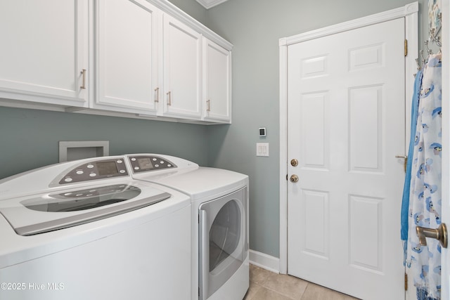 4106 Kittiwake Ct, Southport, NC 28461 - laundry area featuring independent washer and dryer, cabinet space, light tile patterned flooring, and baseboards