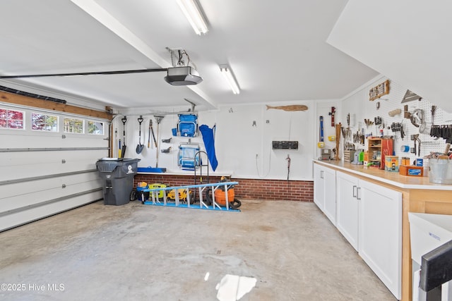 4106 Kittiwake Ct, Southport, NC 28461 - garage featuring a workshop area and a garage door opener