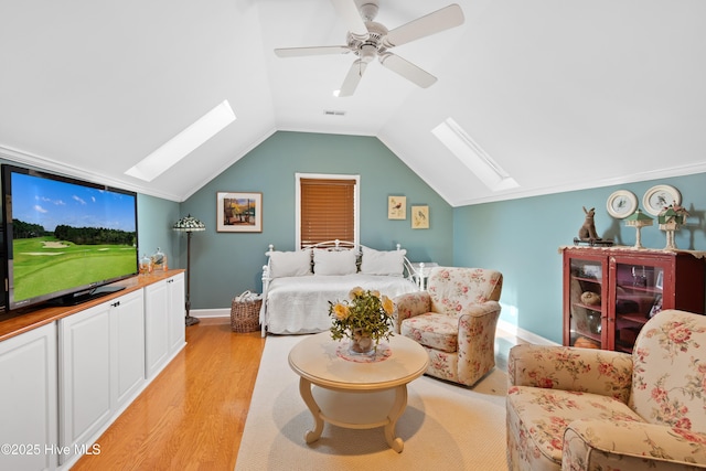 4106 Kittiwake Ct, Southport, NC 28461 - living room with a skylight, light wood-style floors, lofted ceiling, baseboards, and a ceiling fan