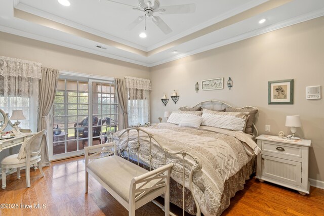 4106 Kittiwake Ct, Southport, NC 28461 - bedroom with access to outside, a raised ceiling, light wood-type flooring, ornamental molding, and recessed lighting