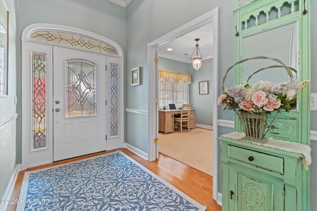 4106 Kittiwake Ct, Southport, NC 28461 - foyer with light wood-type flooring, ornamental molding, and baseboards
