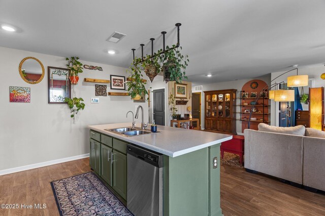 kitchen with visible vents, dishwasher, a sink, and green cabinetry