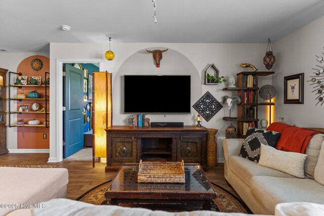 living room featuring baseboards and wood finished floors