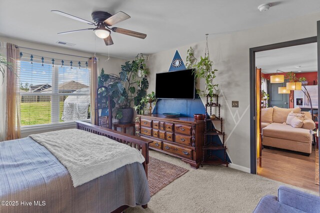 bedroom featuring a ceiling fan, baseboards, carpet, and visible vents