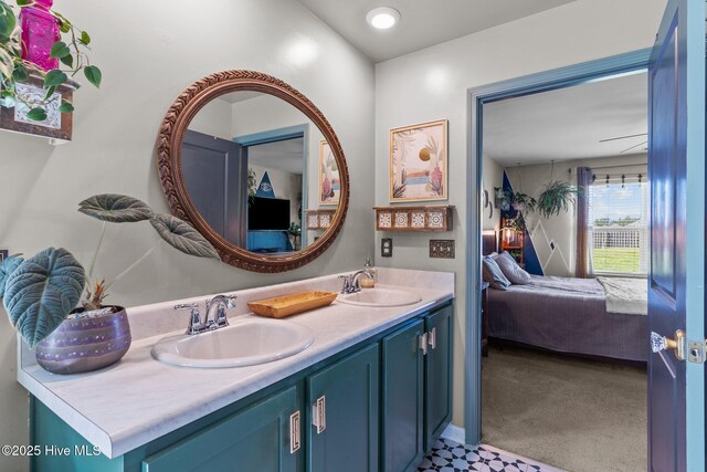 ensuite bathroom with double vanity, ensuite bath, and a sink