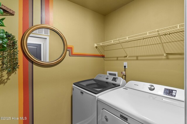 laundry area featuring washer and clothes dryer and laundry area