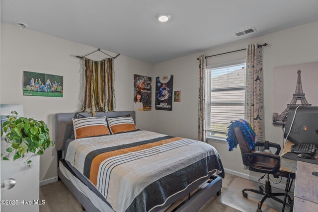 carpeted bedroom with visible vents and baseboards