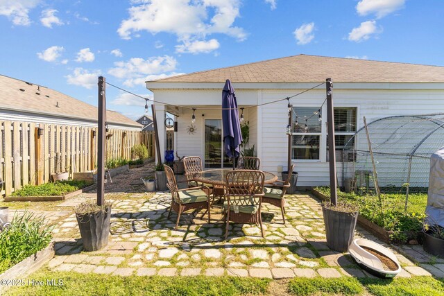 rear view of house featuring a yard and a fenced backyard