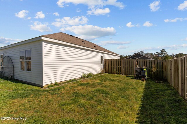 view of yard with a patio, a garden, and a fenced backyard