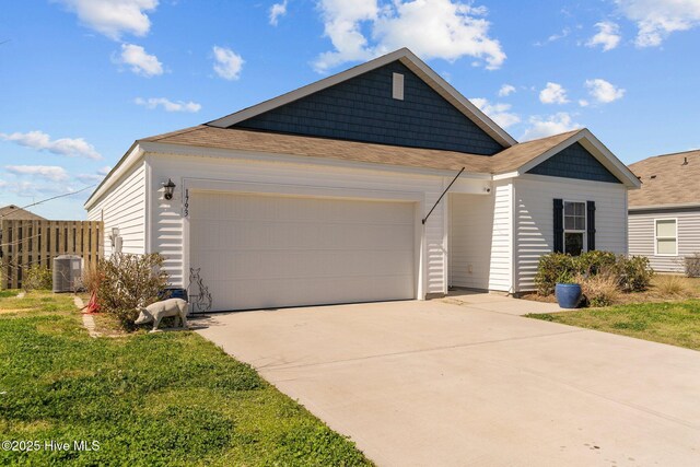 single story home featuring concrete driveway, a front lawn, central AC, a garage, and a shingled roof