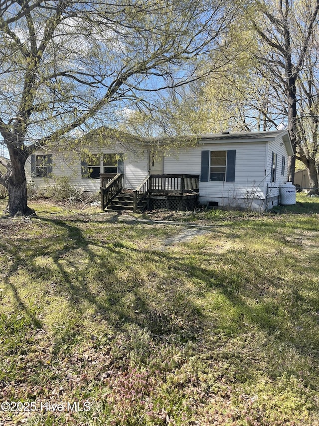 view of front of home with a deck, crawl space, and a front yard