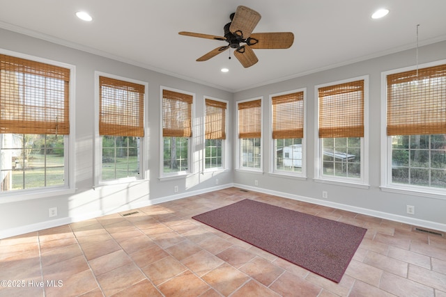 unfurnished sunroom with ornamental molding, baseboards, and visible vents