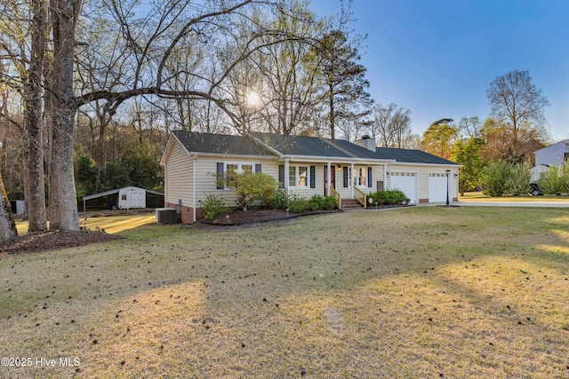 ranch-style house with an attached garage, central air condition unit, a chimney, and a front yard