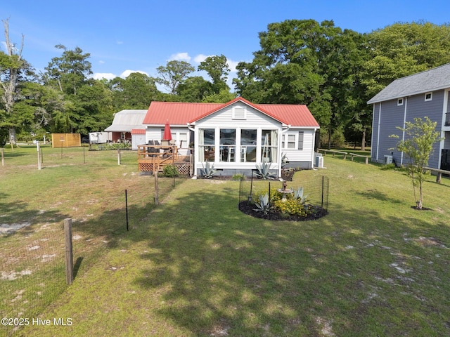 3582 Norman Dr SW, Supply, NC 28462 - rear view of house with a deck, metal roof, and a sunroom