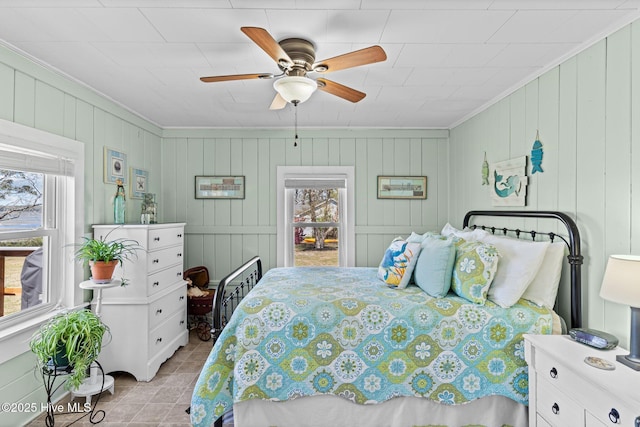 3582 Norman Dr SW, Supply, NC 28462 - bedroom featuring multiple windows, ornamental molding, a ceiling fan, and wooden walls