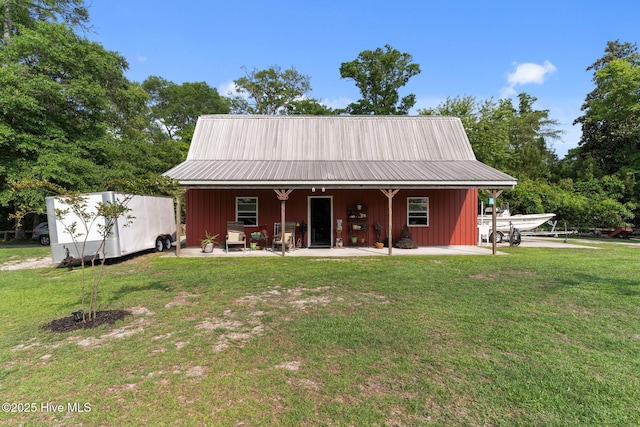 3582 Norman Dr SW, Supply, NC 28462 - view of front of home with a front yard, metal roof, and board and batten siding