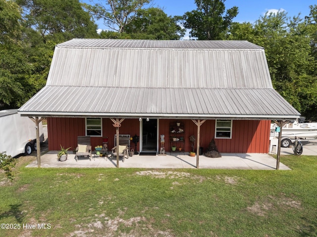 3582 Norman Dr SW, Supply, NC 28462 - rear view of house with a lawn, a patio area, and metal roof