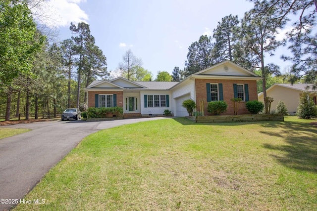 single story home with brick siding, a front yard, an attached garage, and aphalt driveway