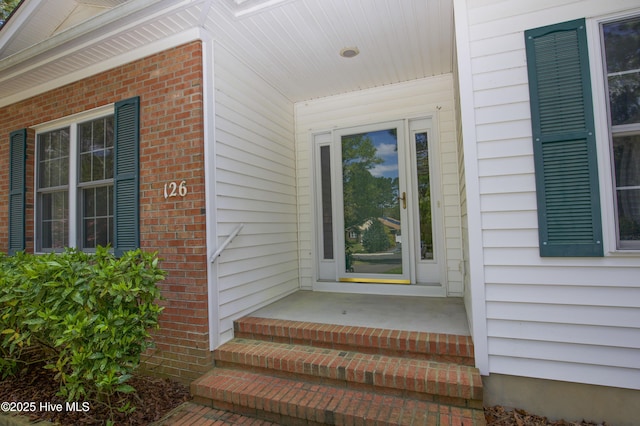 entrance to property with brick siding