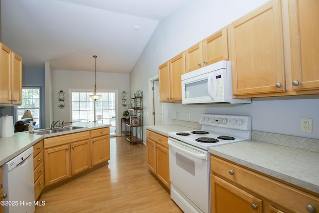 kitchen with light wood-type flooring, white appliances, light countertops, lofted ceiling, and a sink