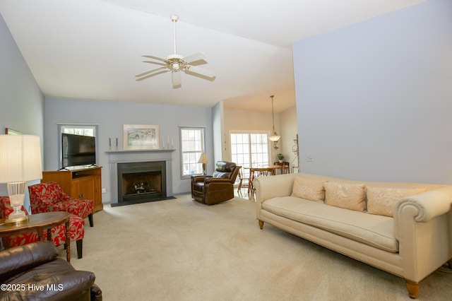 living room with light colored carpet, ceiling fan, lofted ceiling, and plenty of natural light