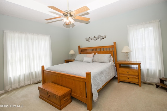 bedroom featuring visible vents, ceiling fan, and light carpet