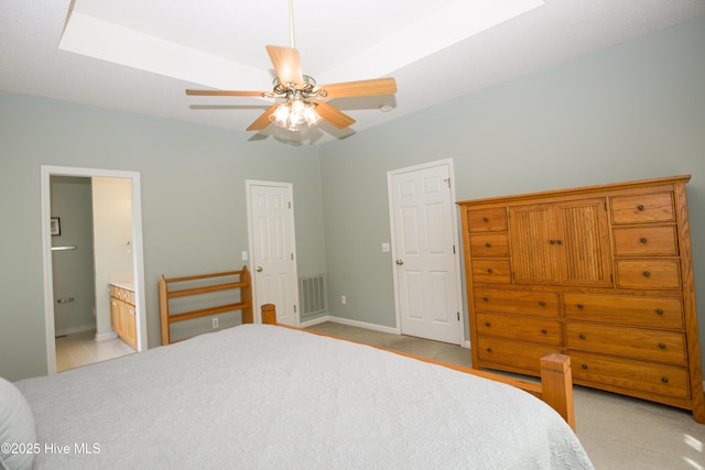 bedroom featuring ensuite bath, visible vents, baseboards, and ceiling fan
