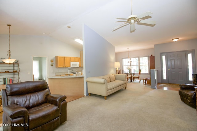 living room featuring a ceiling fan, light colored carpet, and lofted ceiling